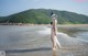 A woman in a bikini standing in the water.