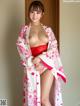 A woman in a kimono posing for the camera.