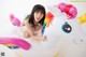 A little girl sitting on top of an inflatable unicorn.